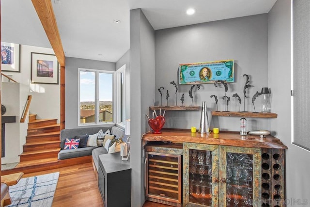 bar with wine cooler, butcher block counters, and light hardwood / wood-style flooring