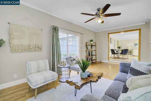 living room with ornamental molding, ceiling fan, and light hardwood / wood-style flooring