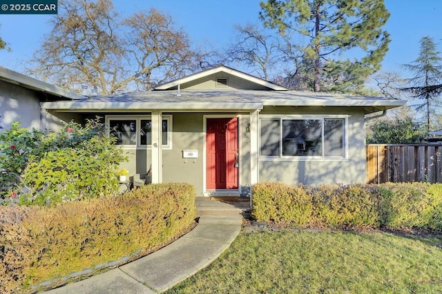 bungalow-style home featuring a front yard