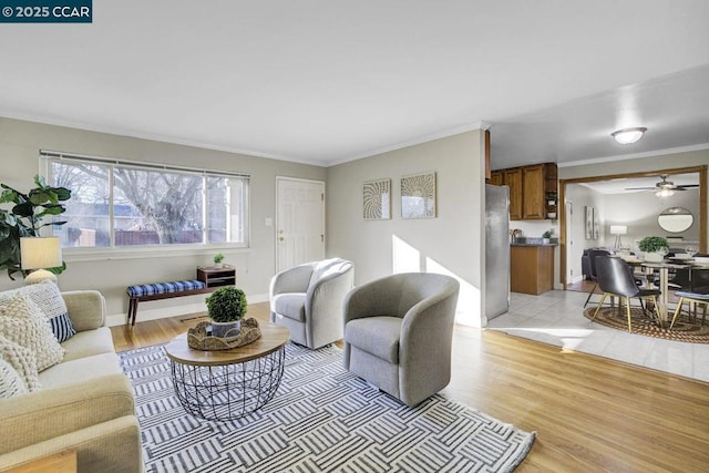 living room with crown molding and light hardwood / wood-style flooring