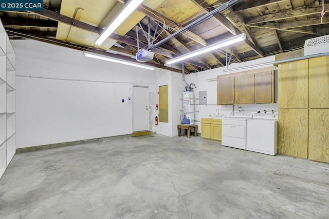 garage with a garage door opener, washing machine and clothes dryer, secured water heater, and electric panel