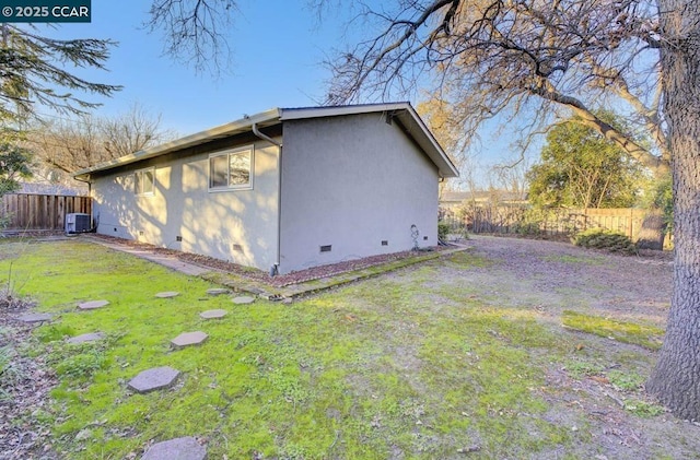 view of property exterior featuring a yard and central AC unit