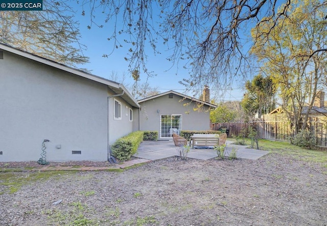 rear view of house with a patio and outdoor lounge area