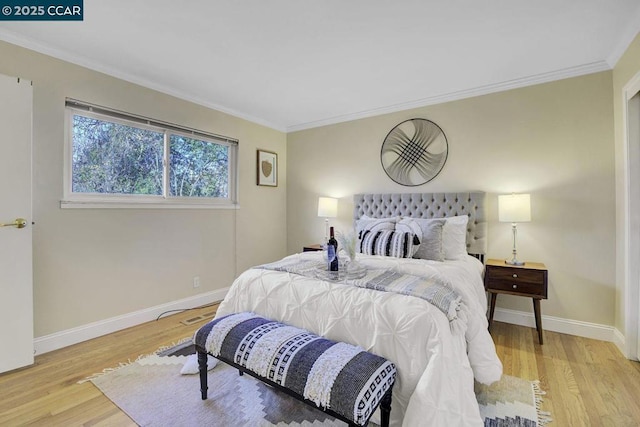 bedroom featuring ornamental molding and light wood-type flooring