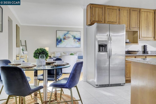 kitchen with ornamental molding and stainless steel fridge with ice dispenser