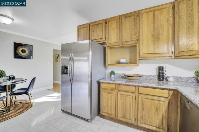 kitchen featuring light stone counters, ornamental molding, and stainless steel appliances