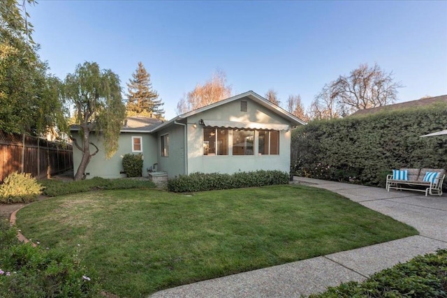 exterior space with a front yard and a patio