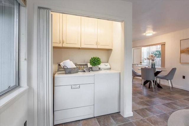 washroom with separate washer and dryer and cabinets