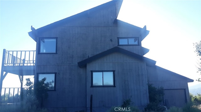 view of side of property with a balcony