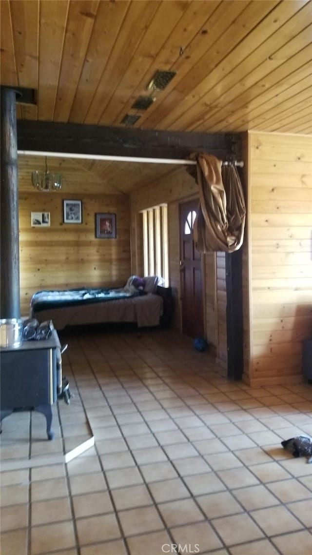 unfurnished bedroom featuring tile patterned flooring, wood ceiling, wooden walls, and beamed ceiling