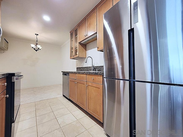 kitchen featuring sink, light tile patterned floors, appliances with stainless steel finishes, ornamental molding, and dark stone counters