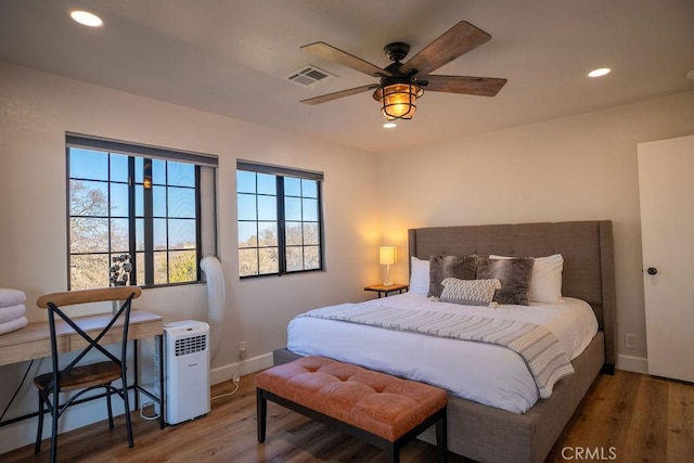 bedroom with recessed lighting, wood finished floors, and visible vents