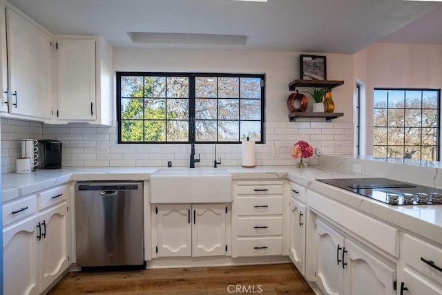 kitchen with a sink, white cabinetry, black electric stovetop, dishwasher, and a healthy amount of sunlight