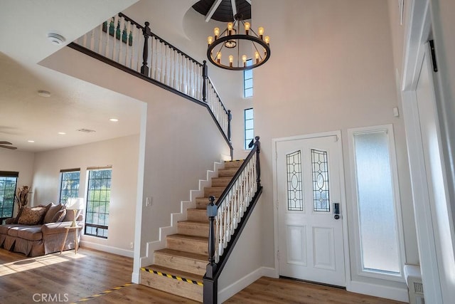 entryway with stairway, baseboards, and wood finished floors