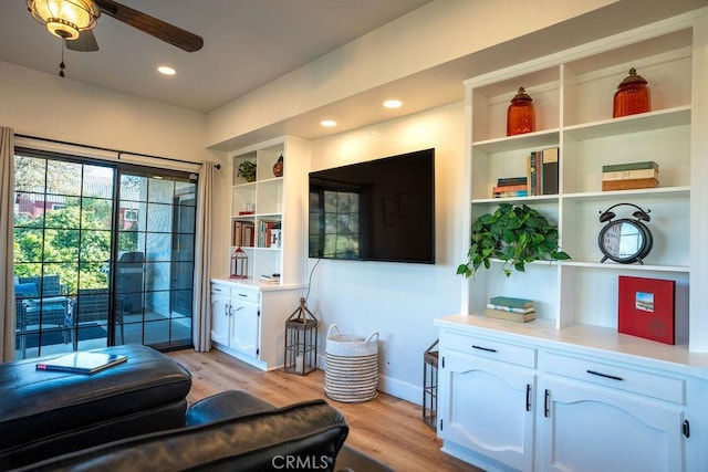 living area featuring ceiling fan, baseboards, light wood-style flooring, and recessed lighting