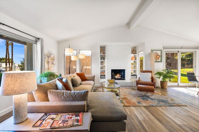 living room with hardwood / wood-style flooring, plenty of natural light, and a brick fireplace