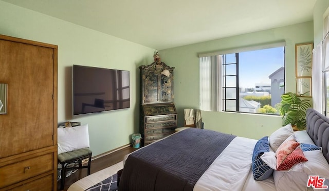 bedroom featuring dark hardwood / wood-style flooring