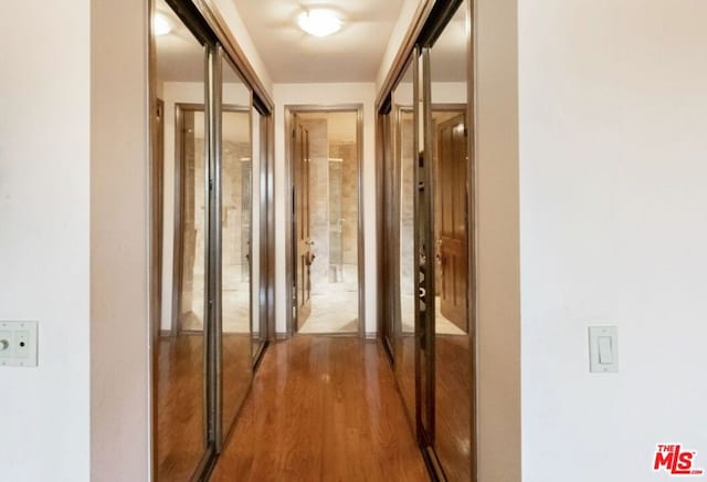 hallway with wood-type flooring