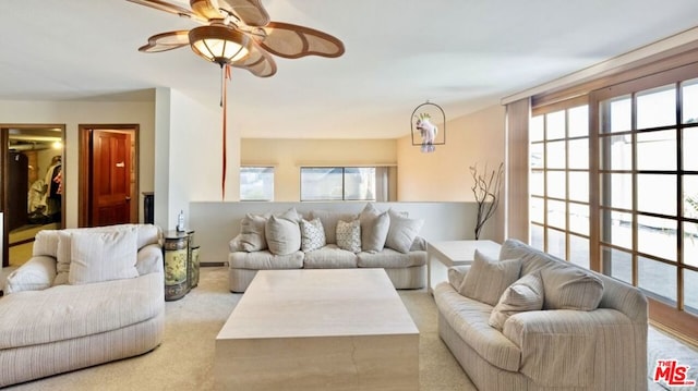 living room with plenty of natural light and light colored carpet