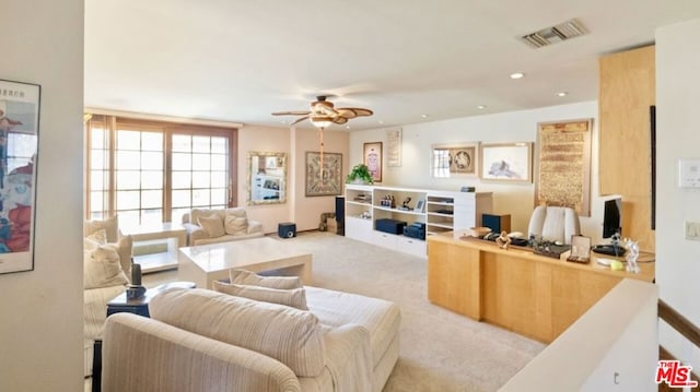 carpeted living room featuring ceiling fan