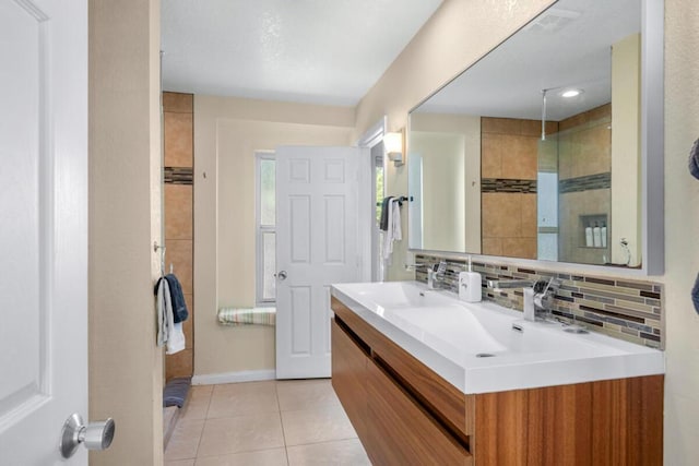 bathroom with vanity, tile patterned flooring, and backsplash