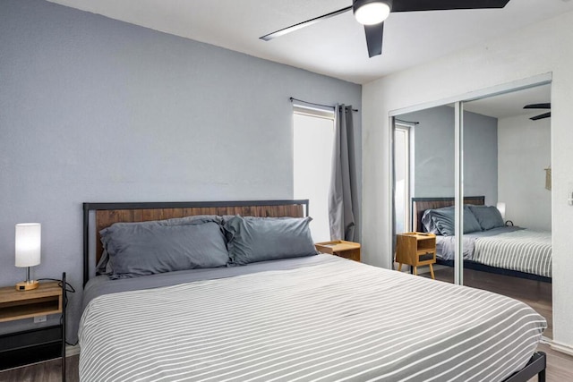 bedroom with dark hardwood / wood-style floors, ceiling fan, and a closet