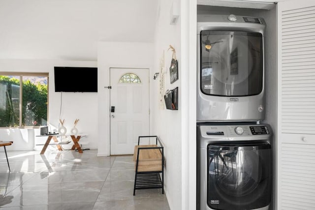 clothes washing area with stacked washer / drying machine