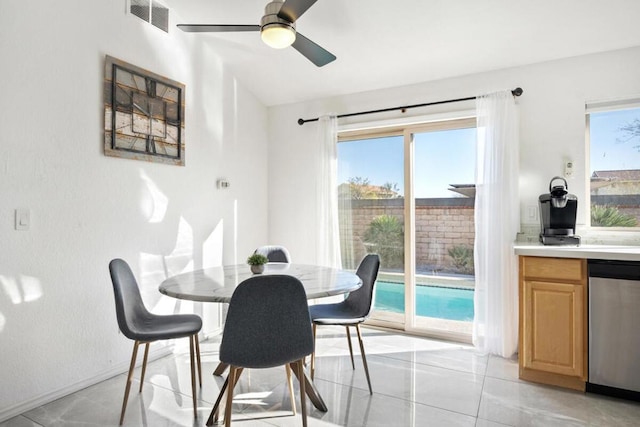 tiled dining area with ceiling fan