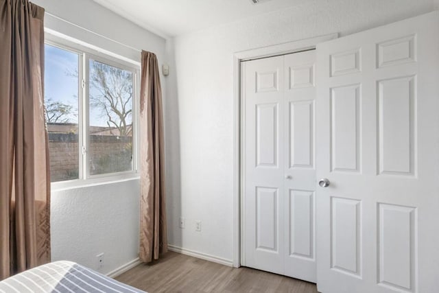 bedroom featuring light wood-type flooring and a closet