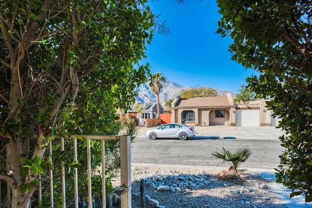 exterior space featuring a garage and a mountain view