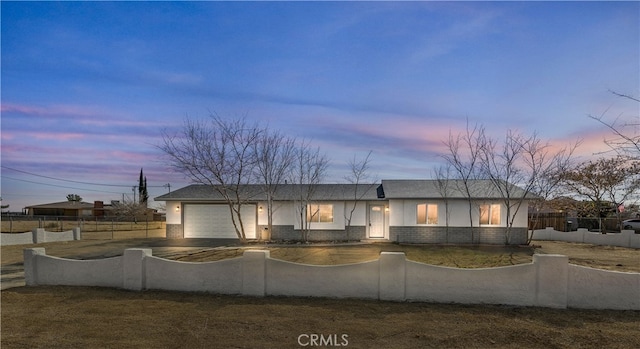 ranch-style home featuring a garage