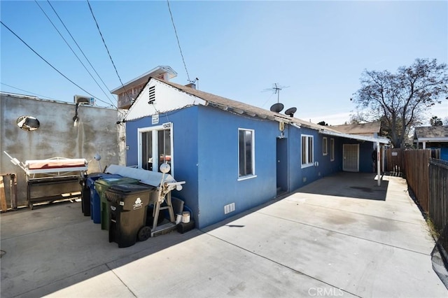 view of side of property with a patio area