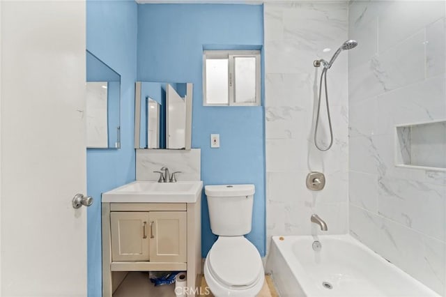 full bathroom with tiled shower / bath, vanity, and toilet