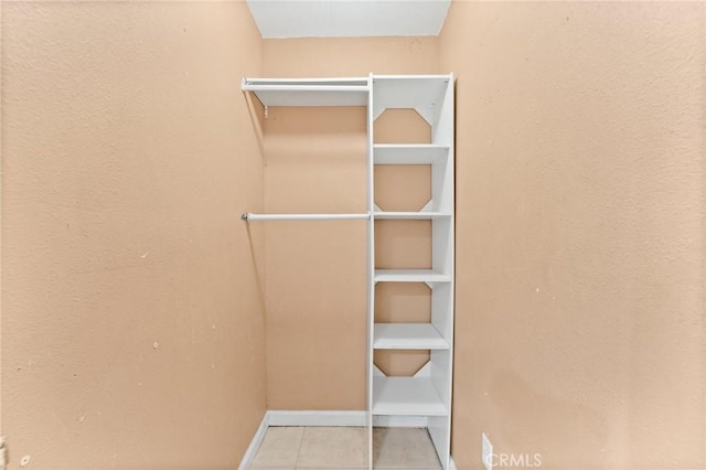 spacious closet featuring light tile patterned flooring