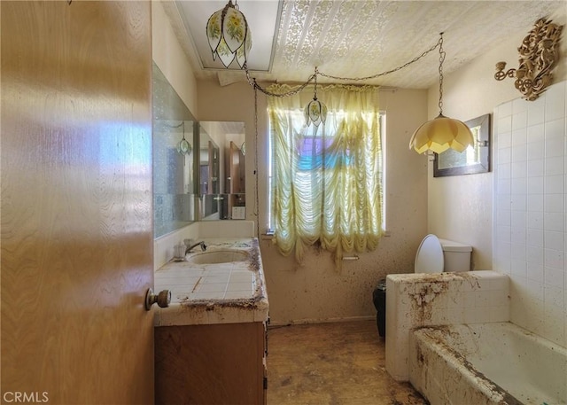 bathroom with vanity, a washtub, and toilet