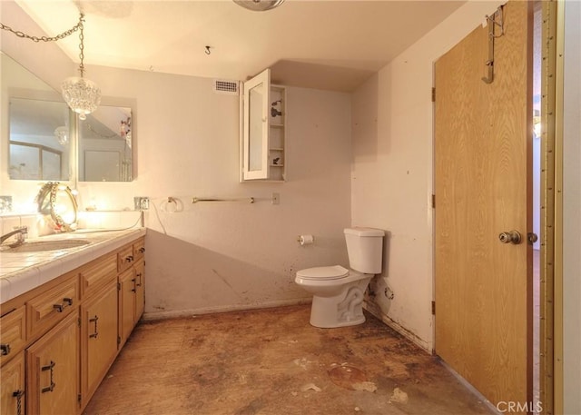 bathroom featuring vanity, toilet, and concrete flooring