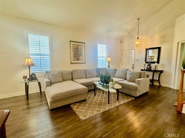 living room featuring vaulted ceiling and dark hardwood / wood-style flooring