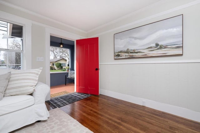 entrance foyer featuring crown molding and hardwood / wood-style flooring