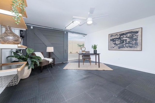 office area featuring ceiling fan and a barn door