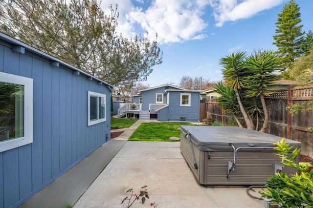 view of patio featuring a hot tub and a deck