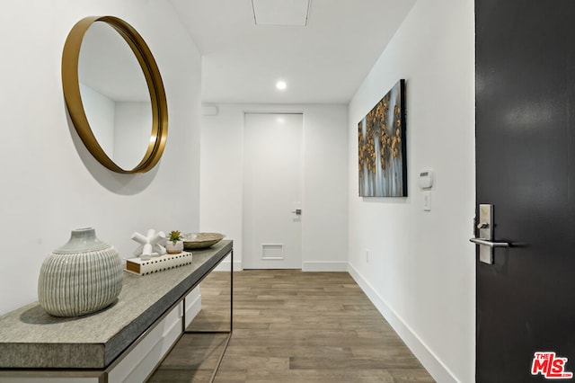 hallway with light hardwood / wood-style flooring