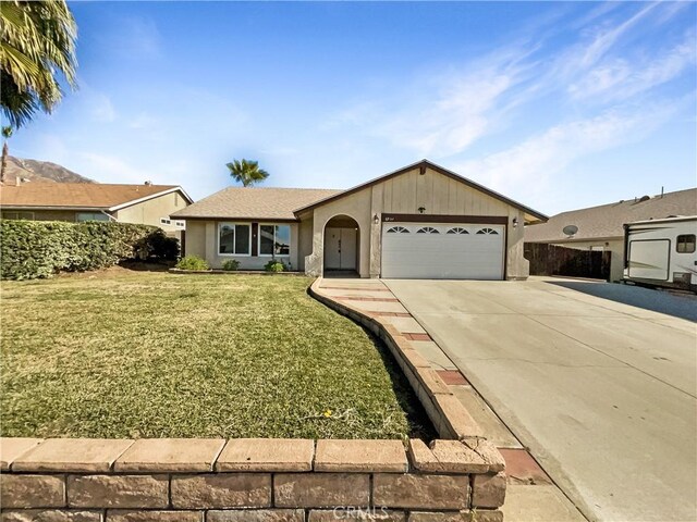 ranch-style home with a garage and a front lawn