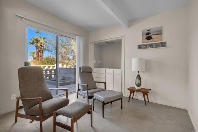 living area featuring beamed ceiling