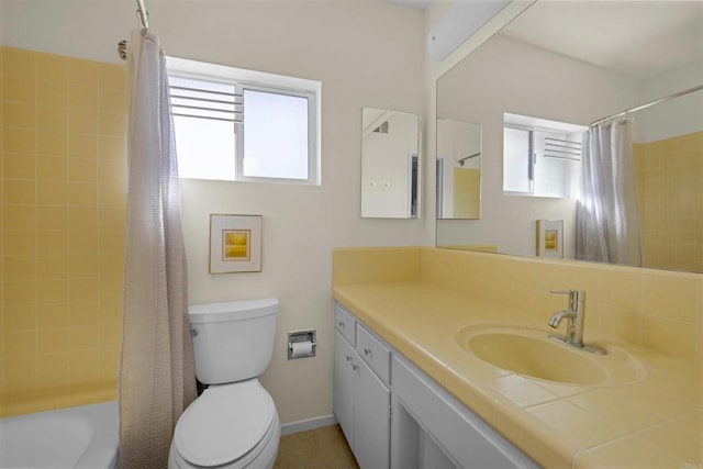 full bathroom featuring shower / bathtub combination with curtain, vanity, and toilet