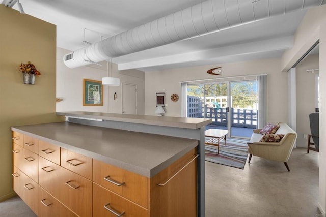 kitchen featuring kitchen peninsula and hanging light fixtures