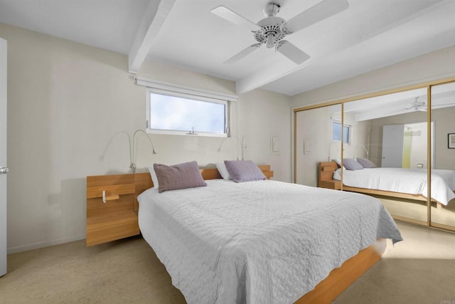 bedroom with beamed ceiling, carpet floors, ceiling fan, and a closet