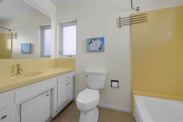 full bathroom with tiled shower / bath, vanity, and toilet