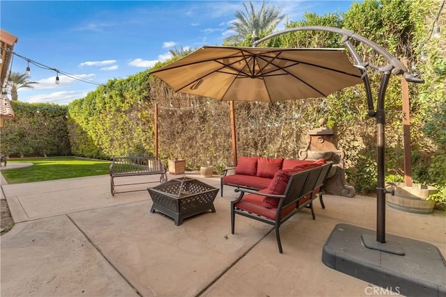 view of patio with an outdoor living space with a fire pit