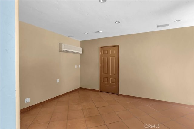 empty room featuring a wall mounted AC and light tile patterned flooring