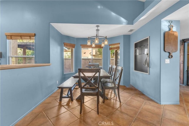 dining space featuring a chandelier and light tile patterned floors